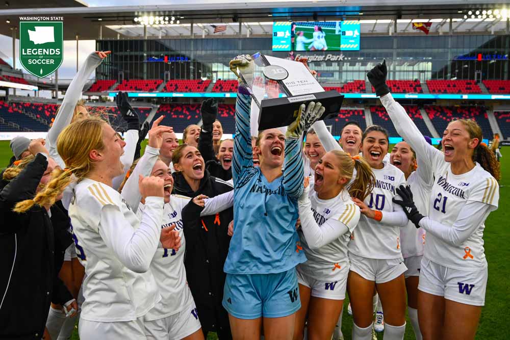 Washington's Tanner Ijams, who made two shootout saves, lifts the 2025 Big Ten tournament championship trophy in St. Louis, completing the Huskies' double. (UW Athletics)