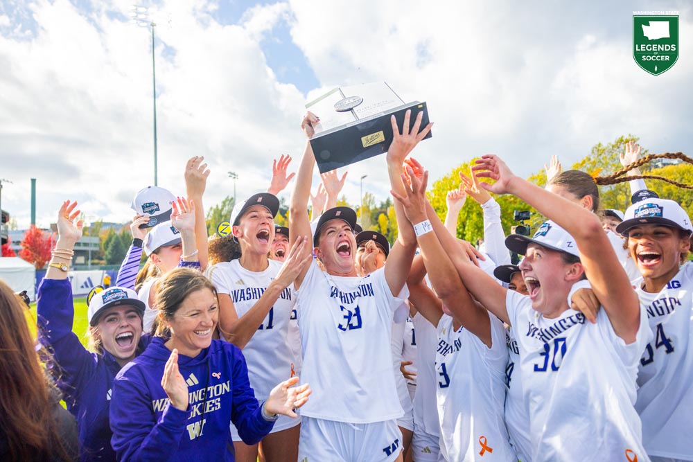 Washington players and Coach Nicole Van Dyke posed with their newly won 2025 Big Ten regular season championship trophy following their 1-0 home win over Wisconsin. (UW Athletics)