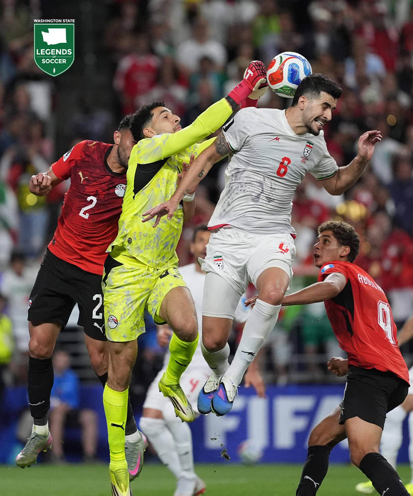 Egypt goalkeeper Mostafa Shobeir (yellow) strains to punch clear a cross as Iran's Saeid Ezatolahi (6) challenges in the 2026 FIFA World Cup  Group G match on June 26. (Corky Trewin)